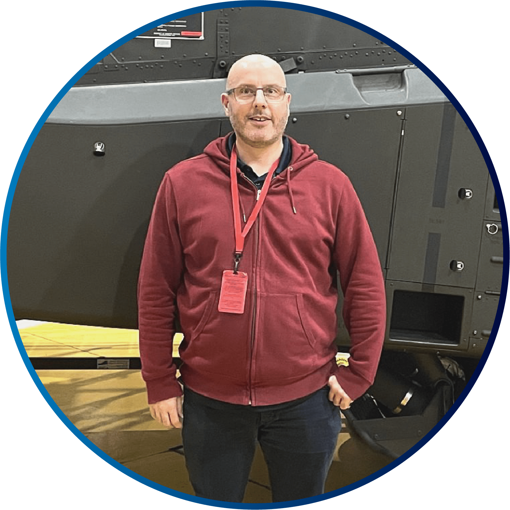 World Engineering Day - 4 March 2026 2 A circle image showing a man in a red top, stood in front of an aircraft smiling