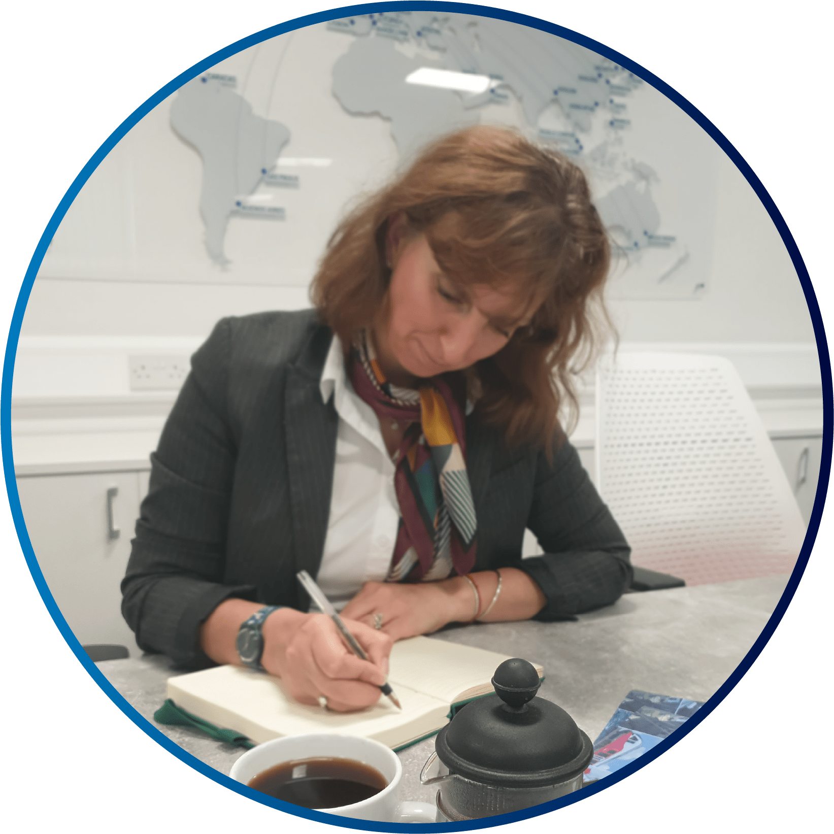 World Engineering Day - 4 March 2026 3 A circle image of a smartly dressed woman, sat at a desk, writing in a notepad