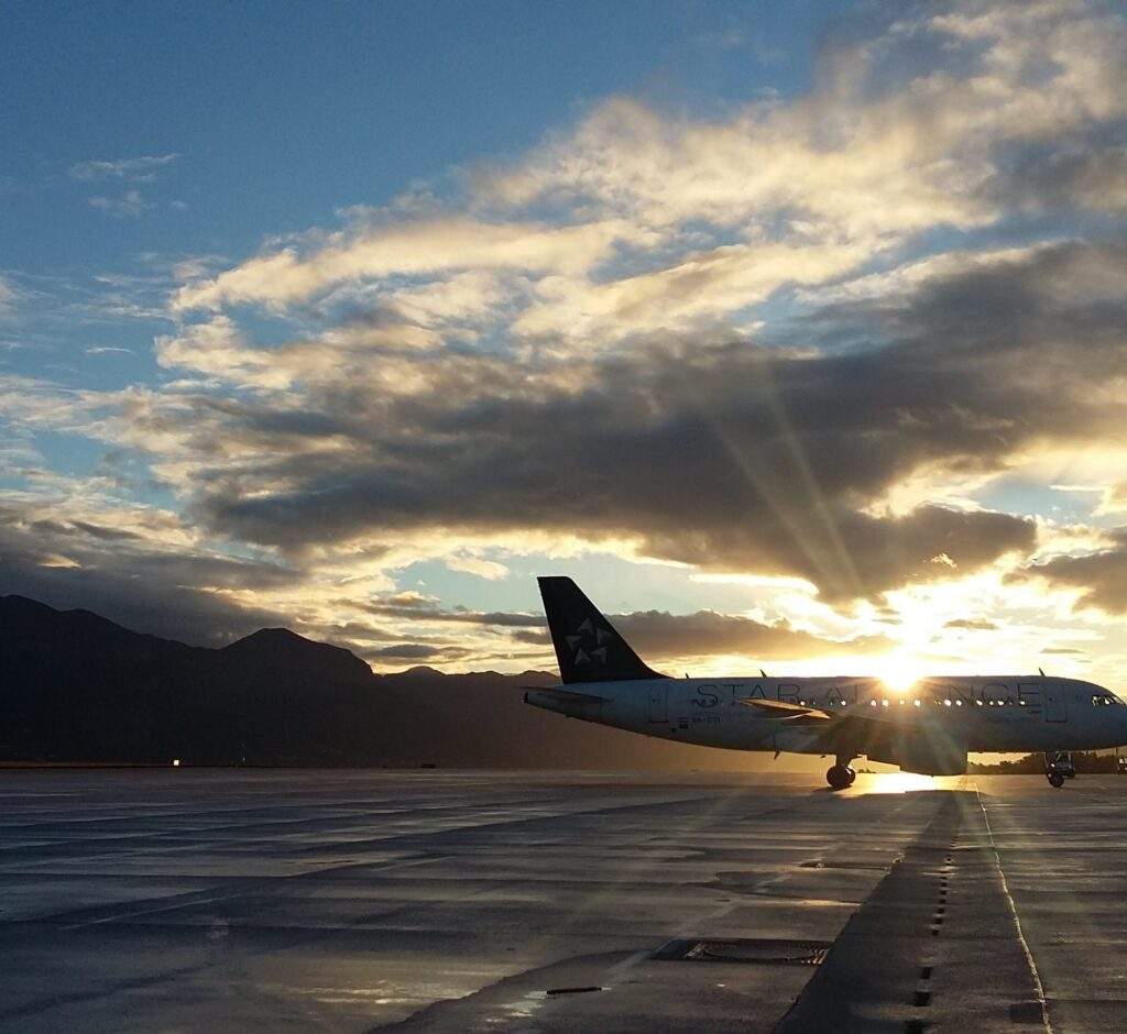 EVA Aviation now a Partner 31 An airport runway. The sky is blue with the sun setting over an aeroplane