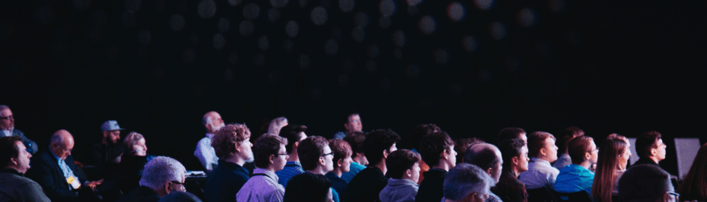 What Events Are Ahead for Pennant in 2025 27 A crowd of people sat in a dark theatre conference room look in the same direction