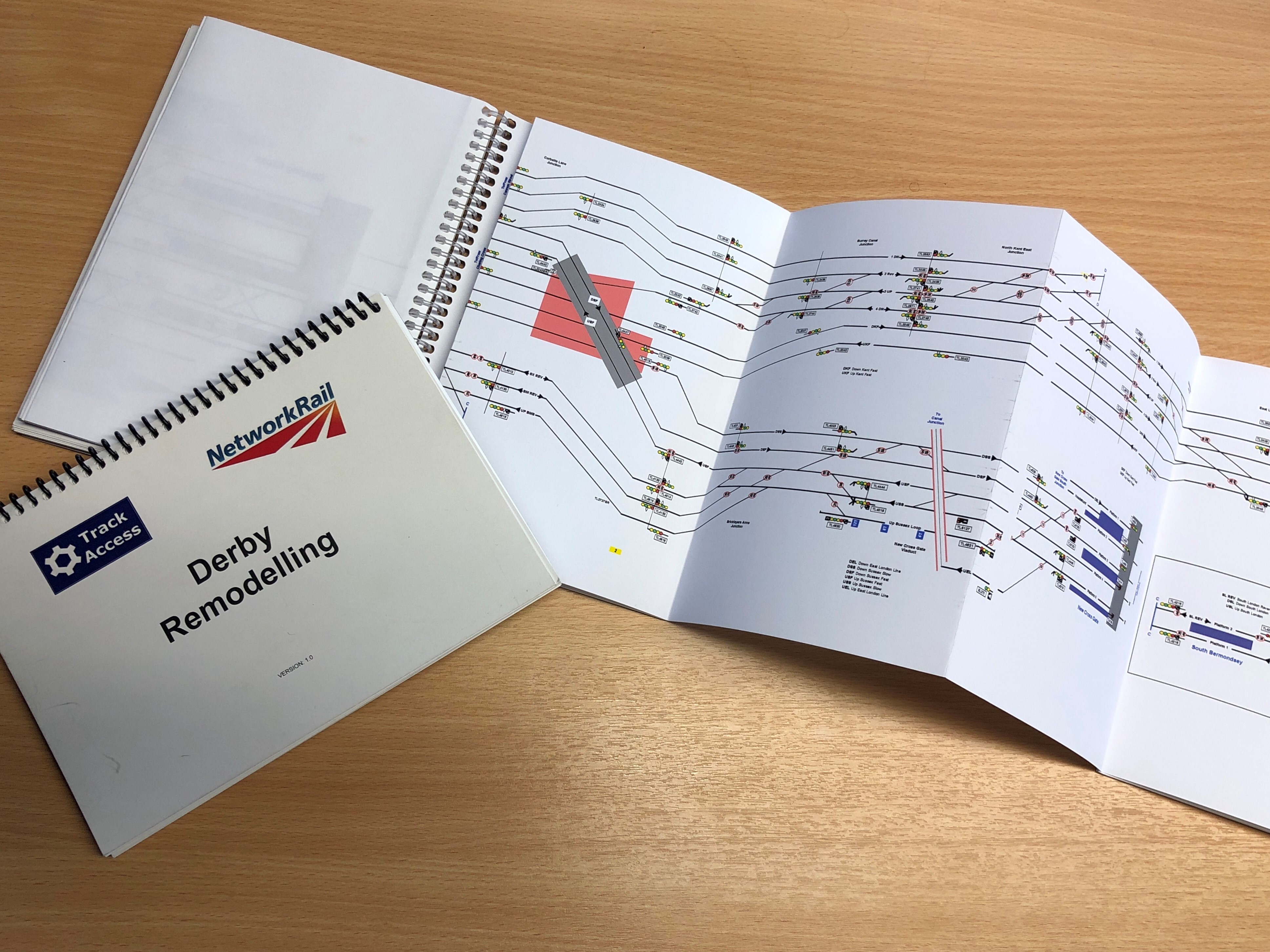 A set of driver briefings maps printed on white paper laid out on a desk